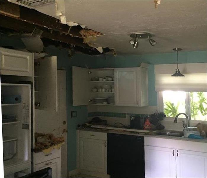 fire damaged ceiling, debris on counter tops in kitchen