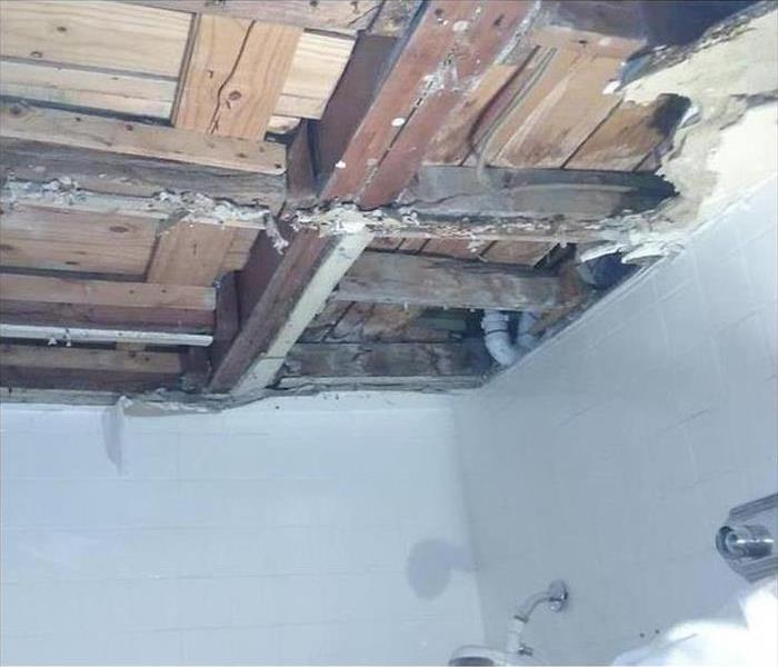 exposed ceiling, plumbing, and boards