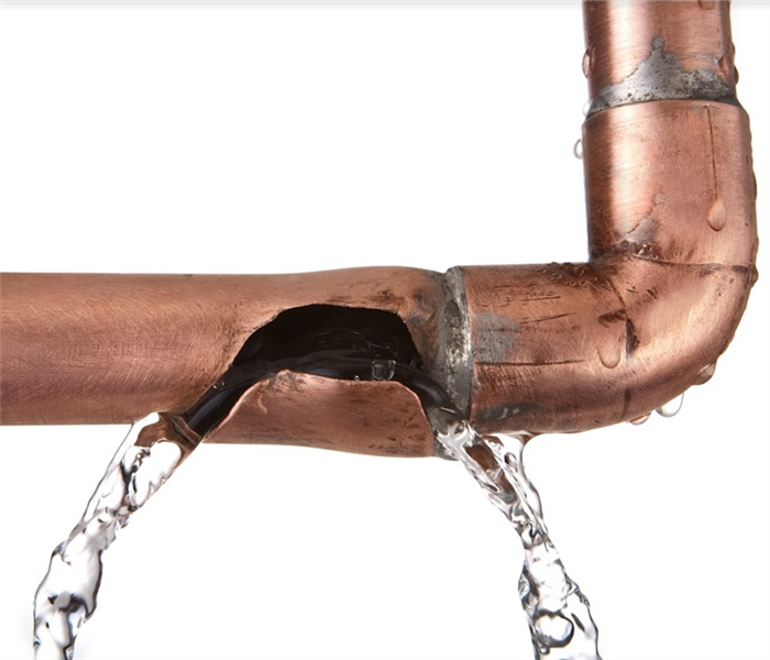 a broken copper pipe that is leaking water