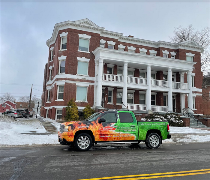 a SERVPRO truck parked in front of a commercial business building